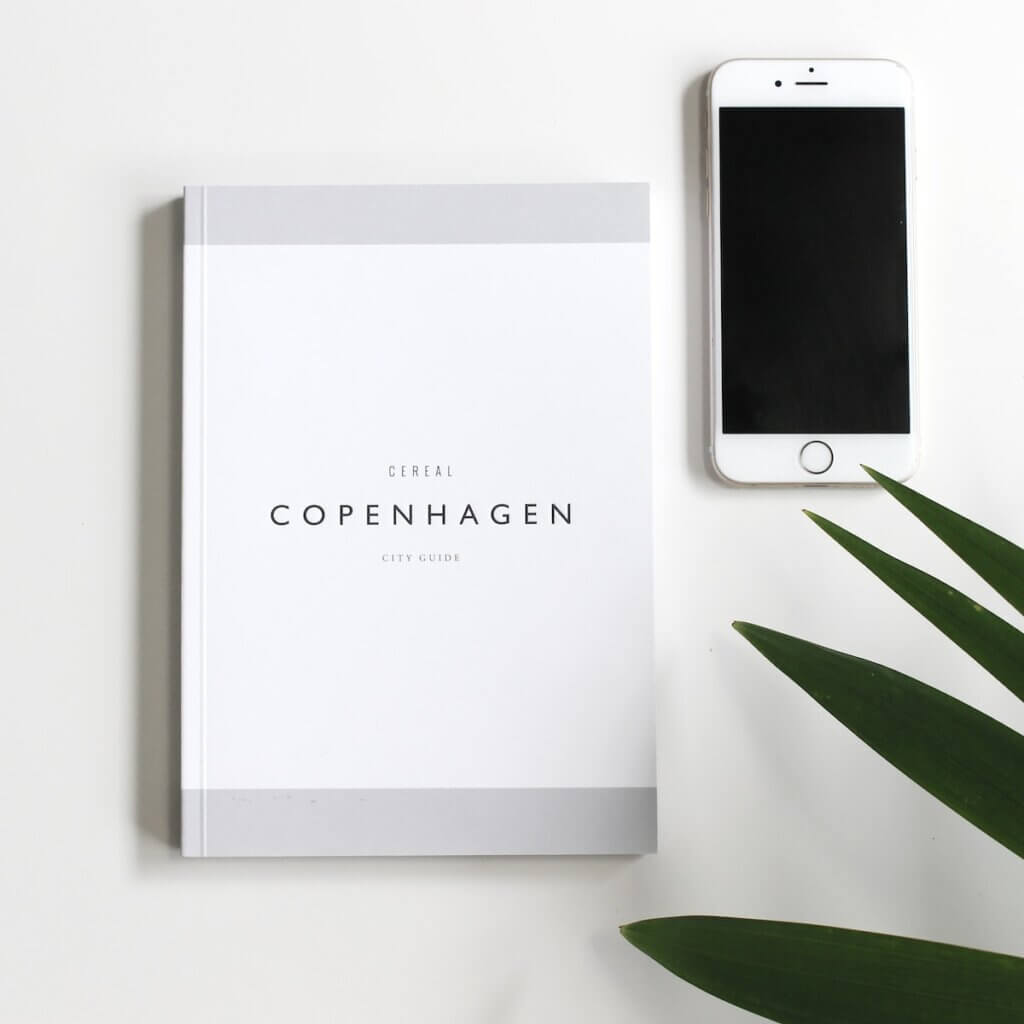 Copenhagen book beside iPhone 6